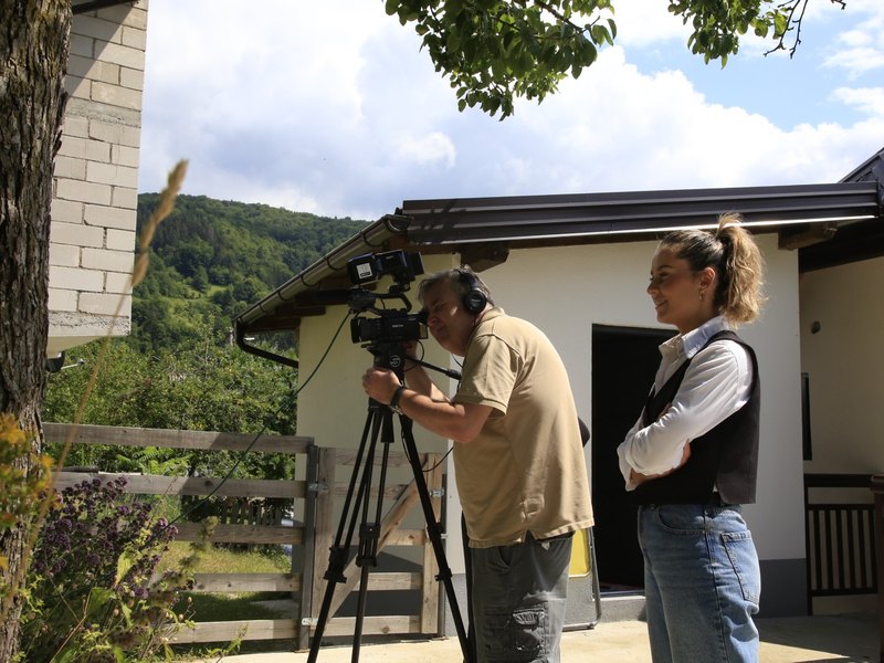 A camera crew filming at the house